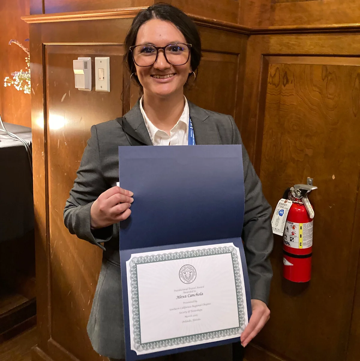 Alexa Canchola holding her SCCSOT award certificate.